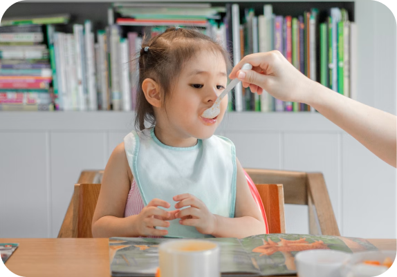 Girl with spoon in mouth